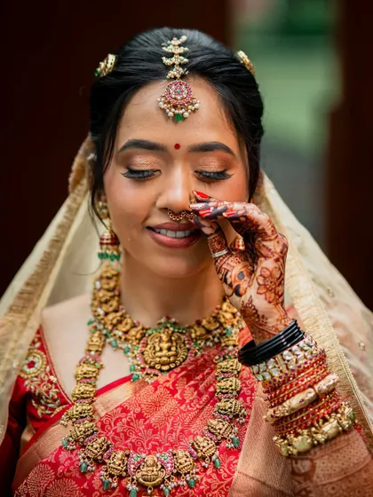 Another close-up, this time with a playful touch to her nose ring, her eyes sparkling.