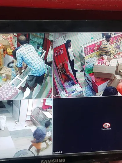A multi-camera view inside the retail store, covering different aisles and the checkout counter.