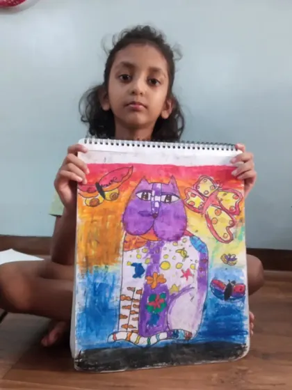 A wonderfully creative cat drawing by Harshita, a 3rd-grade student. She used oil pastels on paper to create a vibrant and imaginative character with unique patterns and colors.