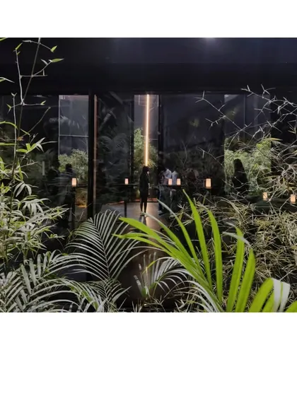 A look through the garden into the black mesh form of the Durall Pavilion. The temporary structure was designed as a folly, a place of respite that could be a church, a meditation hall, or simply a beautiful space to pause.