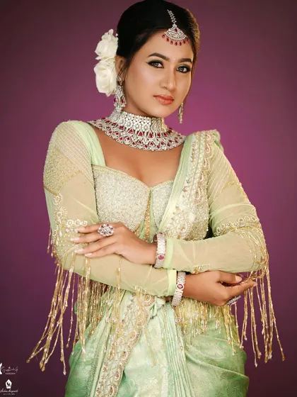 A modern reception look with a beautiful light green saree and designer blouse.
