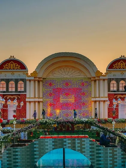 A spectacular, custom-built stage designed to look like a European town square at sunset. This shows our ability to create large-scale, highly thematic, and imaginative wedding decor.