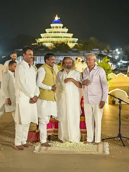 Gurudev shares a light-hearted moment with guests during his birthday celebrations. These events are a beautiful blend of profound wisdom and simple, human connection.