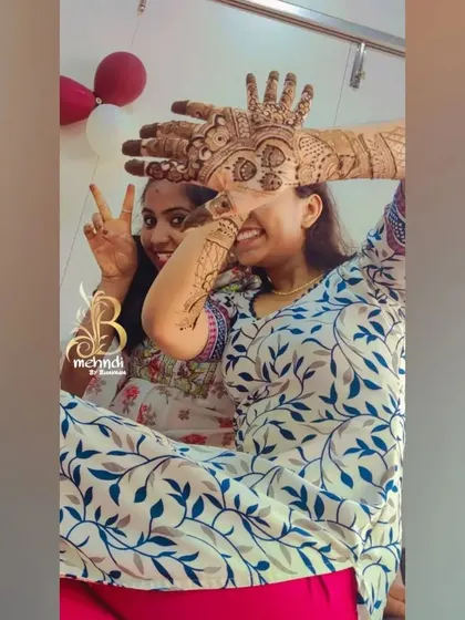 A duplicate of friends enjoying mehndi together.