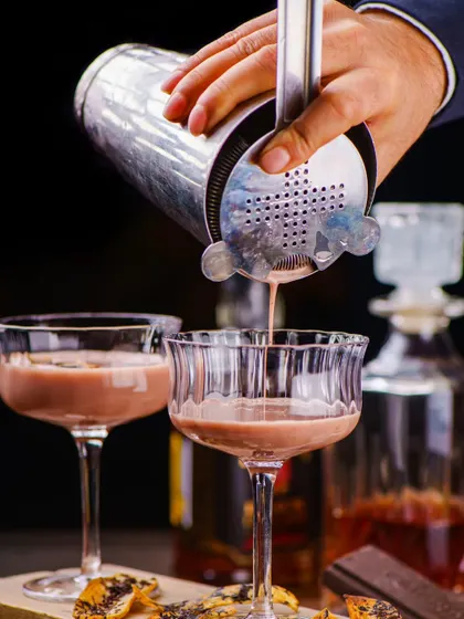 A creamy, dessert-style cocktail being poured, perfect for an after-dinner treat. It's indulgence in a glass.
