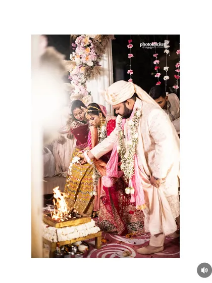 A close-up of the 'saat phere' ritual, focusing on the couple's hands and the sacred fire, symbolizing their lifelong bond.