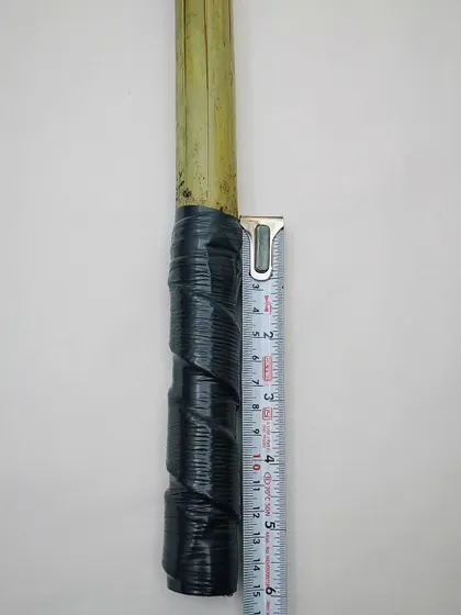 I check every detail, including the measurements. This image shows the handle length of a clatter stick, ensuring it's comfortable and functional for the handler.
