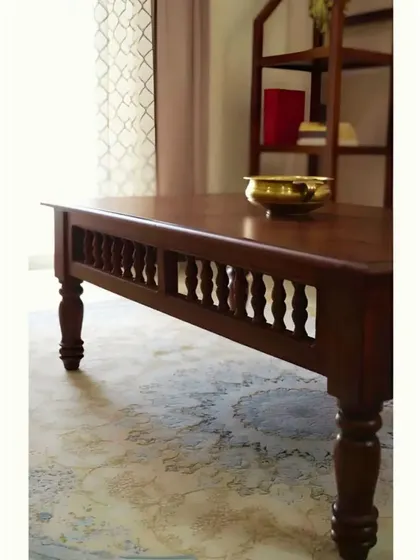 The detailed carving and turned legs of the coffee table are a testament to the skill of our craftsmen.