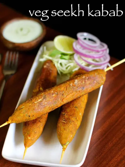 A close-up of our Veg Seekh Kebab, showcasing its perfectly grilled texture. Served with fresh onion rings and a squeeze of lime, it's a simple yet flavorful dish.