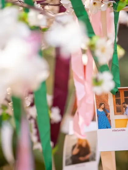 A wishing tree decorated with ribbons and photos of the couple. This is a lovely, interactive element where guests can hang their wishes for the couple.