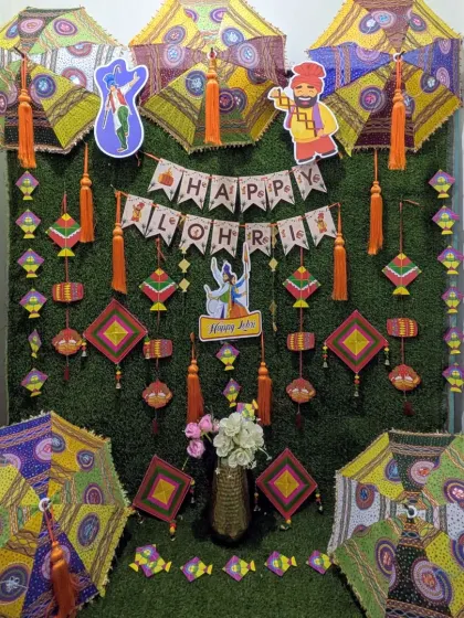 For a Lohri celebration at home, I created this fun and traditional backdrop using a faux grass wall, phulkari umbrellas, kites, and other Punjabi folk elements.