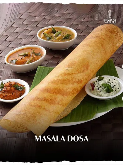 The iconic Masala Dosa, crispy on the outside, with a delicious spiced potato filling. Served with our fresh chutneys and sambar, it's a taste of South India.