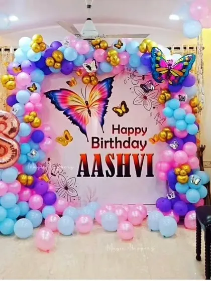 A vibrant butterfly-themed backdrop for a home birthday party. I use a mix of blue, pink, and purple balloons with gold accents and butterfly cutouts to create a beautiful photo corner.
