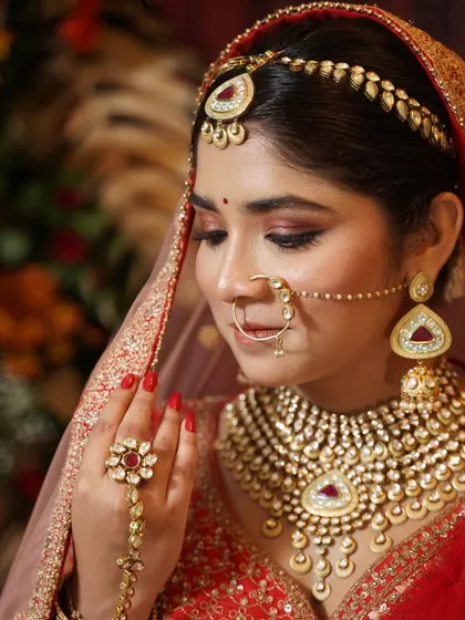 A close-up of the signature red bridal look. The sparkly eyes and flawless base are the highlights of this makeup.