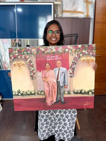 Holding the finished 50th-anniversary painting. It’s a privilege to create artwork that honors such a significant milestone in a couple's life together.