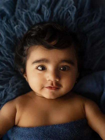 A close-up of a baby's beautiful, expressive eyes. These milestone sessions are perfect for capturing those fleeting facial details.