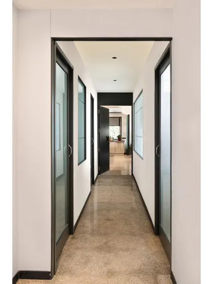 Corridors are more than just passages; they are opportunities for design. In Project Rooftop, I used clean lines, symmetry, and a strong contrast of black and white to create this sleek passageway. The glass doors maintain a sense of openness while defining separate spaces.