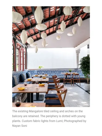 I retained the existing Mangalore tiled ceiling and arches on this balcony to preserve its character. The space is furnished with custom fabric lights and patterned blue seating, creating a breezy, traditional-meets-modern dining spot.