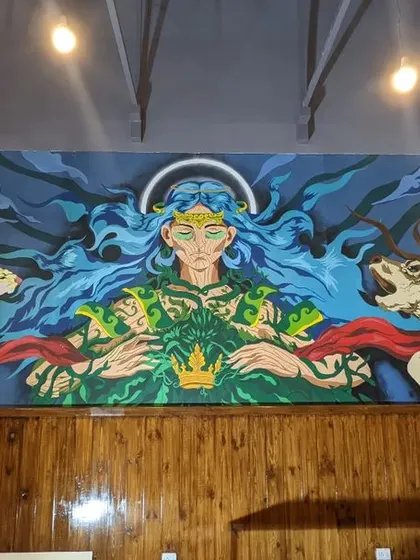 A final look at the full "Mother Nature" mural, capturing its scale and presence within the two story cafe space.