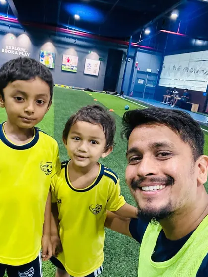 A coach takes a happy selfie with two of our young players. Building a positive and friendly relationship with the kids is a core part of our coaching philosophy.