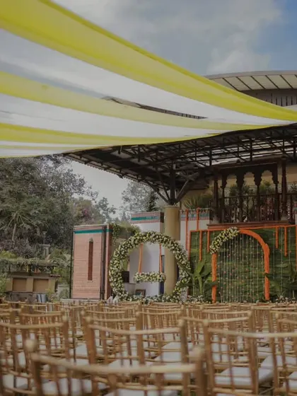 An outdoor naming ceremony setup with yellow and white drapes, creating a bright and cheerful atmosphere for the celebration.