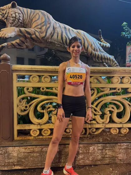 Posing before the start of the Tata Mumbai Marathon. Pre-race preparation is key, and this photo captures the calm and confidence that comes from knowing you've put in the work.