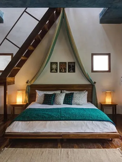 The Tower Room at Jalakara, with a private staircase leading to a rooftop terrace. This room is designed to feel like a romantic hideaway, with a four-poster bed and views out over the island.
