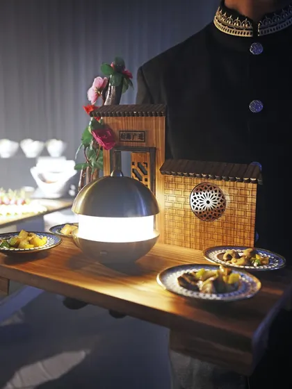 An elegant presentation of our Pan-Asian appetizers, served on a tray with miniature, house-like structures. This theatrical service style is one of our unique signatures.