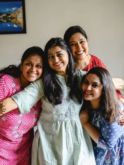 A happy group hug with the bride and her friends. This photo from Poorva's home mehendi radiates warmth and friendship.