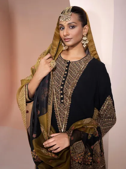 A classic black and gold embroidered suit, perfect for a trousseau. This timeless piece can be worn for years to come at various festive occasions.