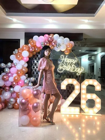 This pose shows off the clear pedestal filled with balloons, a modern touch that adds another layer of detail to the overall decoration.