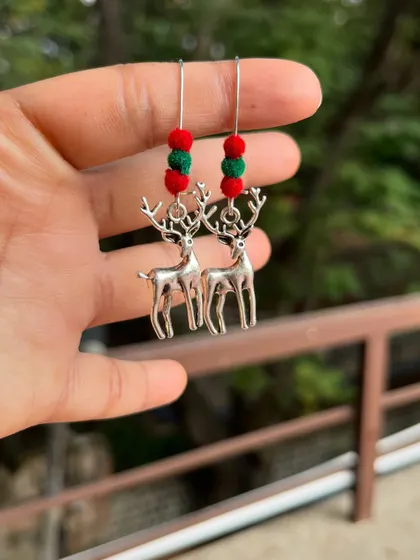 A fun and festive pair of reindeer earrings, perfect for the Christmas season. These budget-friendly oxidised silver earrings feature red and green beads.