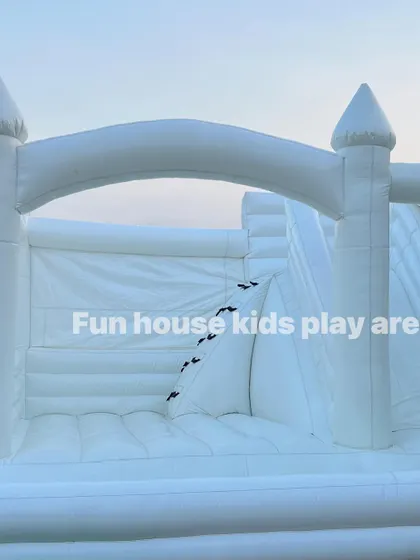 A straight-on view of the white castle's archway, inviting kids to come in and play.