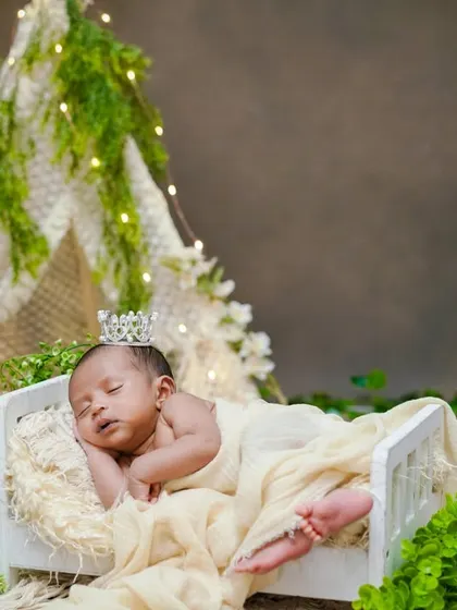 A little prince in his enchanted forest. This setup uses a teepee, greenery, and a tiny crown to create a magical, nature-inspired portrait.
