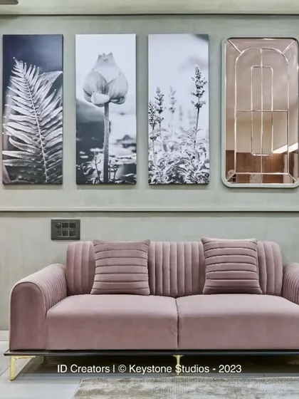The seating area is anchored by a soft rug and nested coffee tables with marble tops, creating a luxurious yet comfortable feel.
