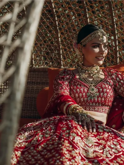 A stunning bride in her traditional red lehenga, a timeless and beautiful sight.
