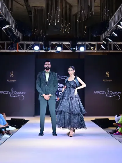 A poised final pose on the runway. I direct models to hit specific marks for photographers, ensuring we capture strong, impactful images of the collection.