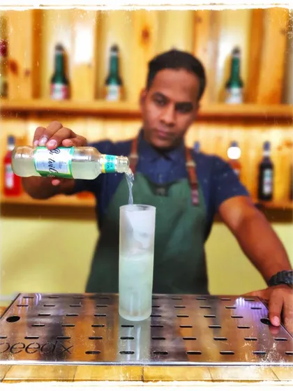 We also cater to non-alcoholic options. Here, a bartender prepares a refreshing mocktail using Britvic Bitter Lemon, showing that great drinks don't always need alcohol.