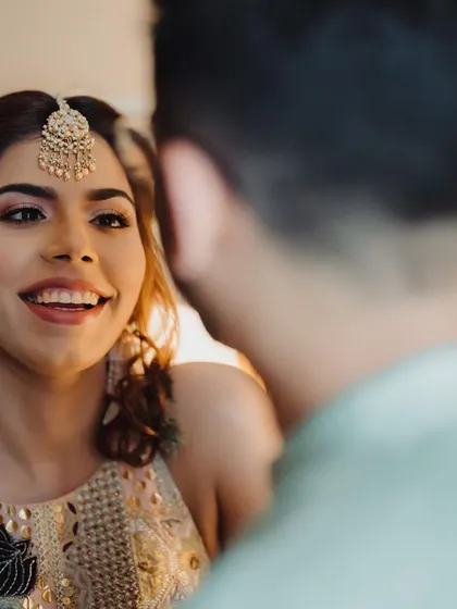 A bride's happy smile as she looks at her groom. This candid shot captures the pure joy and love that radiates from a couple on their wedding day.