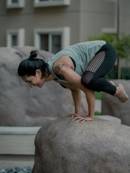 Bakasana, or Crow Pose, on a large rock. Arm balances like this teach us to lean forward into the unknown, trusting our hands and our core to support us.