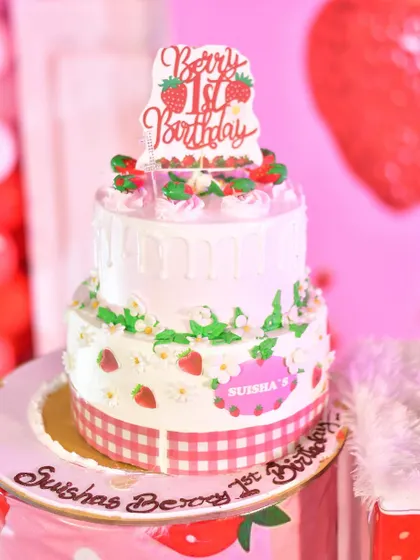 A beautiful two-tiered cake, custom-made for the strawberry theme.