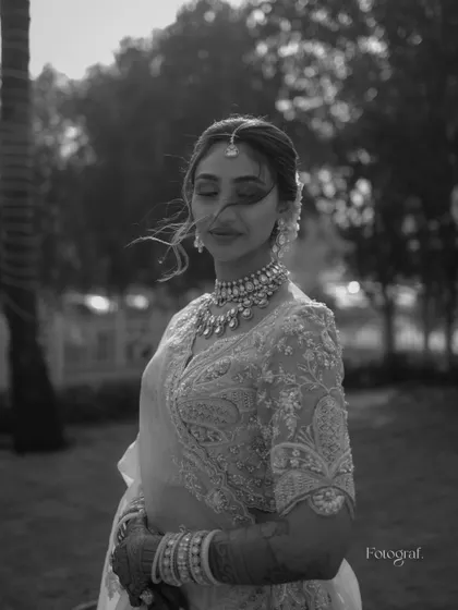 A beautiful black and white bridal portrait with the wind gently blowing her hair. It's a soft, romantic, and timeless shot.