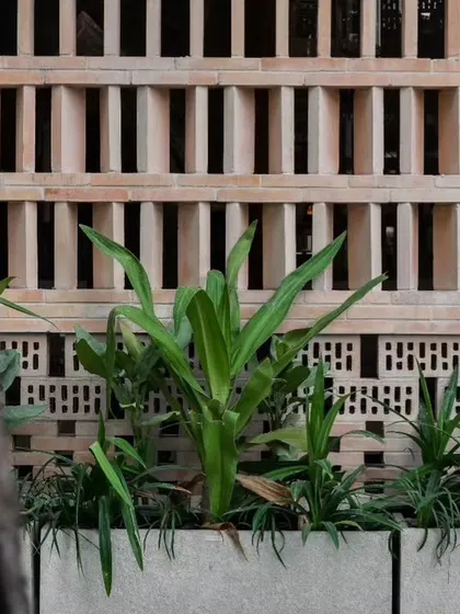 The beauty of handcrafted details is shown in this terracotta jaali brick screen. It not only adds a decorative, traditional element but also allows for natural ventilation and playful light, connecting the interior with the outdoors.
