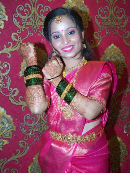 A joyful candid moment of a young woman showing off her henna and bangles during a pre-wedding or festive celebration. It's these happy, spontaneous shots that bring an album to life.