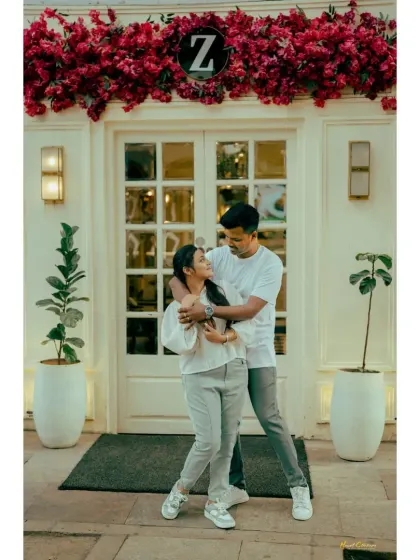 A playful embrace in front of a stylish cafe. This shot is full of life and captures the fun of a city-based pre-wedding shoot.