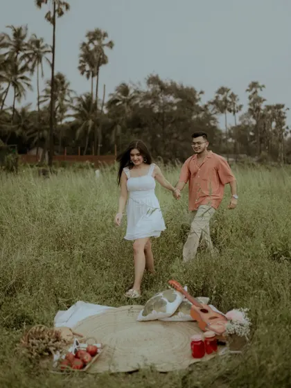 A shot of the couple walking hand-in-hand away from their picnic spot, capturing a sense of journey.