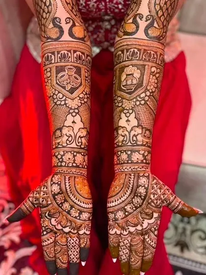 A dense and detailed design featuring shields with auspicious symbols, elephants, and peacocks, perfect for a bride who loves traditional motifs.