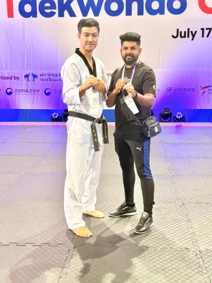 Another photo with a Taekwondo master, sharing a moment of mutual respect.