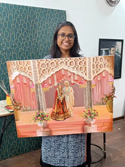 Here I am in my studio with the completed painting from the Taj Palace wedding. The final details have been added, and the artwork is ready to be cherished forever.
