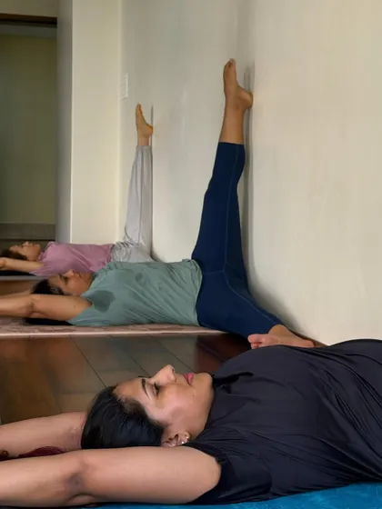 A variation of a wall-supported stretch to open the hips and release the lower back after a long day of sitting.